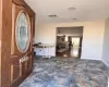 Foyer featuring stone finish flooring, visible vents, ceiling fan, and baseboards