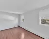 Unfurnished room with a baseboard radiator and wood finished floors