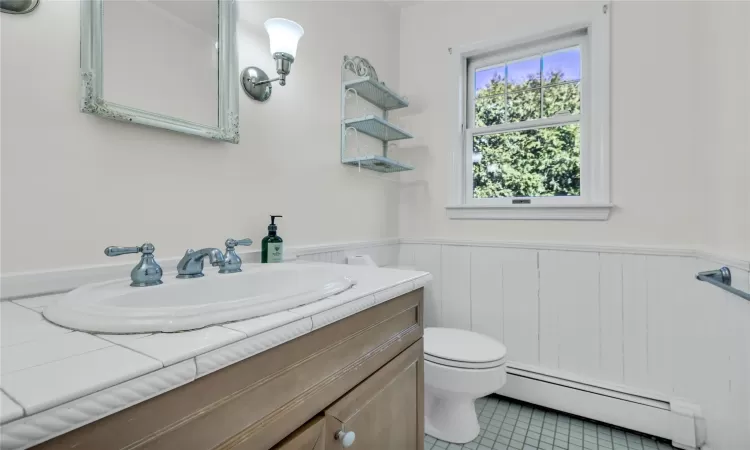 Half bathroom featuring wainscoting