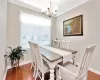 Dining room featuring baseboards, ornamental molding, a chandelier, and wood finished floors