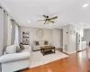 Living room featuring ornamental molding, recessed lighting, visible vents, and wood finished floors