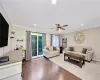 Living area featuring crown molding, wood finished floors, and recessed lighting