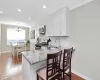 Kitchen featuring stainless steel appliances, wood finished floors, a sink, tasteful backsplash, and crown molding