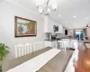 Dining area with dark wood-style floors, recessed lighting, crown molding, and ceiling fan with notable chandelier