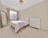 Carpeted bedroom featuring baseboards