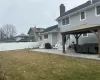 Back of property featuring a patio, fence, a yard, a gazebo, and a chimney