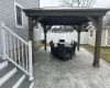 View of patio featuring outdoor dining area, a fenced backyard, and a gazebo