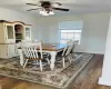 Dining room featuring a wealth of natural light, baseboards, crown molding, and wood finished floors