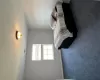 Bedroom with dark colored carpet, visible vents, and baseboards