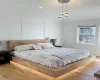 Bedroom with vaulted ceiling, light wood-type flooring, and wood ceiling