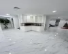 Kitchen with recessed lighting, a sink, visible vents, white cabinets, and glass insert cabinets