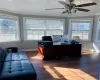 Home office with baseboards, ornamental molding, dark wood finished floors, and a healthy amount of sunlight