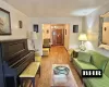 Living area with a notable chandelier and wood finished floors