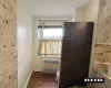 Kitchen featuring radiator heating unit, wood finished floors, and baseboards