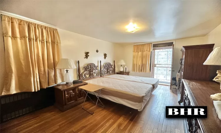 Bedroom featuring access to outside and hardwood / wood-style floors