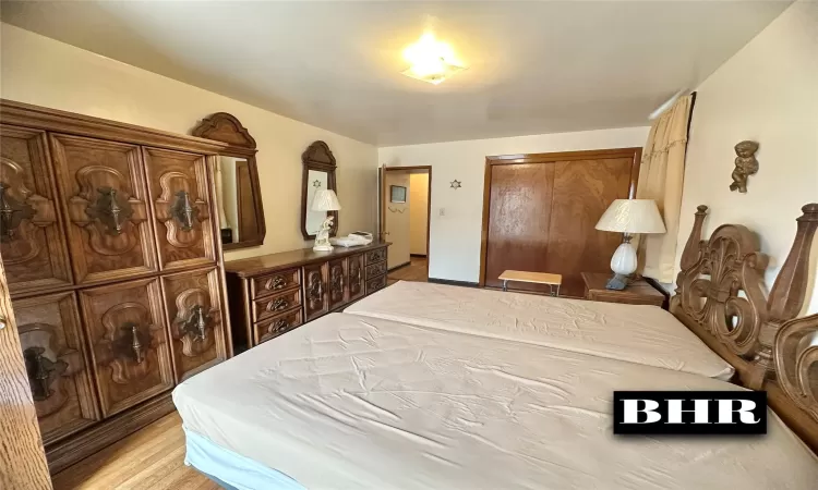 Bedroom featuring a closet and light wood-style flooring