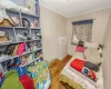 Bedroom with baseboards, wood finished floors, and crown molding