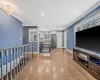 Living area featuring baseboards, recessed lighting, light wood-style flooring, and crown molding