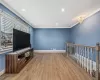 Living area with ornamental molding, baseboards, and hardwood / wood-style floors