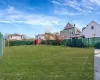 View of yard with a storage shed, a fenced backyard, and an outdoor structure