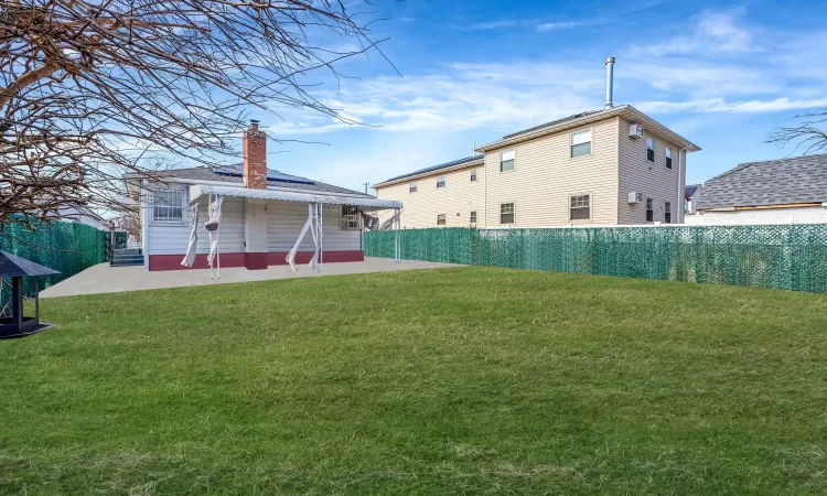 View of yard featuring a patio area and a fenced backyard