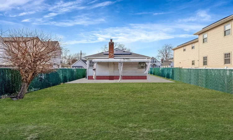 View of yard featuring a patio area and a fenced backyard