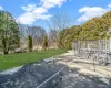 Rear view of property with a lawn and a wooden deck