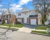 View of front of house featuring a garage, concrete driveway, fence, a front yard, and brick siding