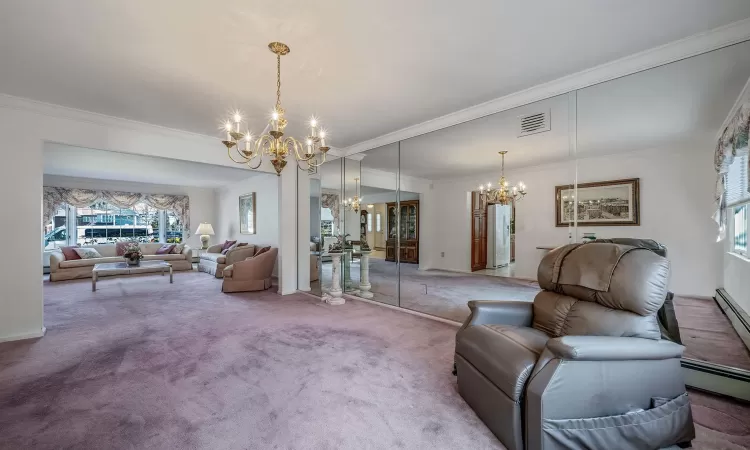 Bedroom featuring a ceiling fan, visible vents, connected bathroom, and light colored carpet