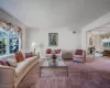 Tiled entryway featuring visible vents, a towering ceiling, carpet, stairs, and ceiling fan with notable chandelier