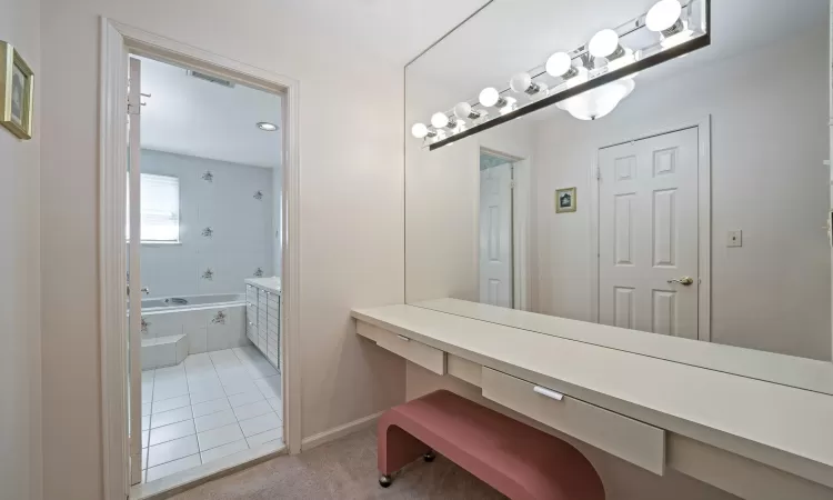 Bathroom featuring a stall shower, vanity, tile walls, and a bath