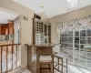 Living room featuring a glass covered fireplace, visible vents, baseboard heating, and light tile patterned floors