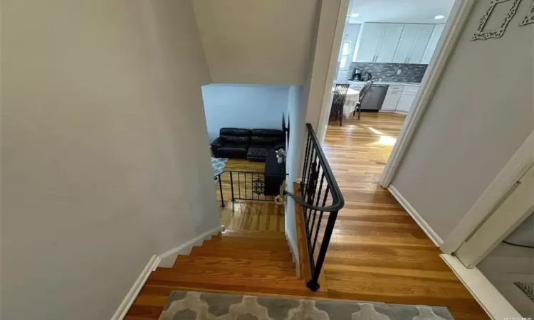 Stairs featuring baseboards and wood finished floors