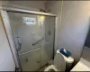 Bathroom with toilet and a stall shower