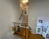 Stairs featuring visible vents, baseboards, and wood finished floors