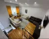 Living area featuring lofted ceiling, wood finished floors, visible vents, and recessed lighting