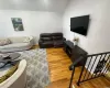 Living room featuring vaulted ceiling and wood finished floors