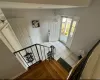 Foyer with light tile patterned floors, lofted ceiling, and baseboards