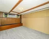 Basement featuring wood walls and wood finished floors