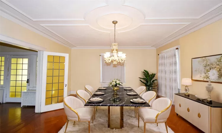 Dining space featuring crown molding and a notable chandelier