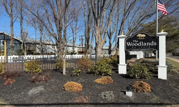 Community / neighborhood sign featuring fence