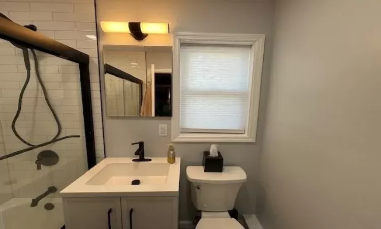 Bathroom featuring toilet, shower / washtub combination, and vanity