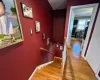 Stairs featuring wood finished floors