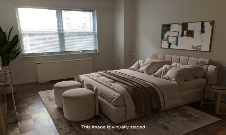 Bedroom featuring baseboards and radiator