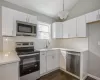 Kitchen with white cabinetry, appliances with stainless steel finishes, and a sink