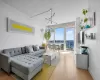 Living room with an inviting chandelier, baseboards, and wood finished floors