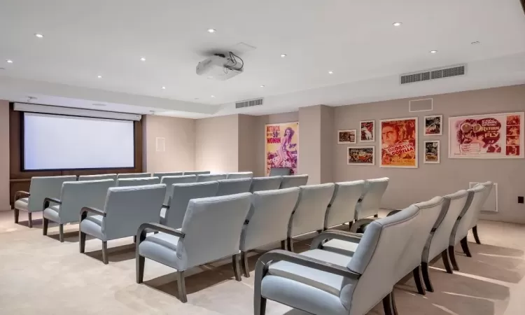 Home theater featuring recessed lighting, visible vents, and light colored carpet