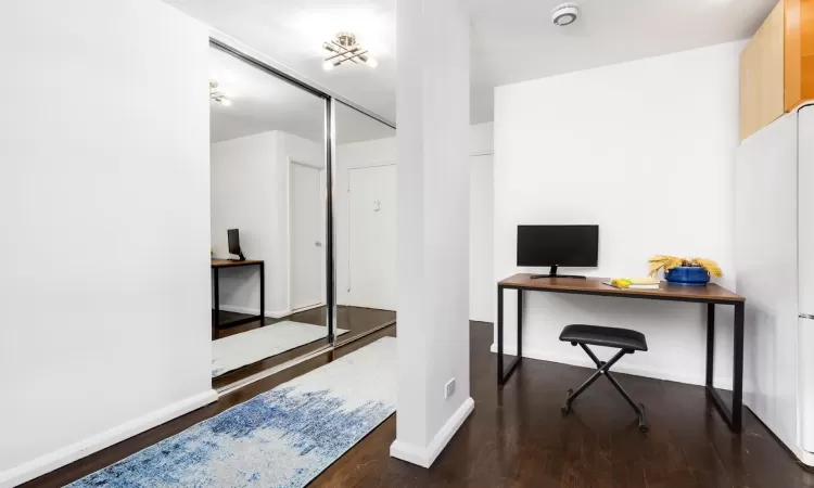 Home office featuring baseboards and wood finished floors