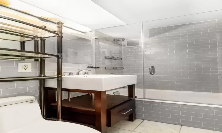 Full bathroom with visible vents, toilet, vanity, tile patterned flooring, and tiled shower