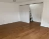 Unfurnished room with wood-type flooring and baseboards